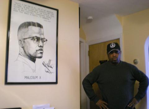 Chuck D, at home with a poster of Malcolm X. Chuck D, at home with a poster of Malcolm X.